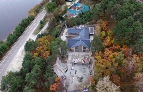 Двухэтажный особняк выполнен в серых цветах и облицован камнем. Внутри находится бассейн под крытым переходом. Фото Life.Ru