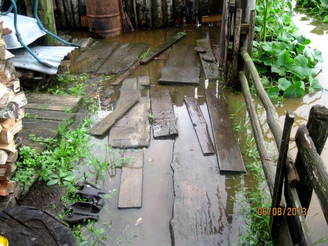 С одной стороны улицы Биракана заливает вода из ключа, а с другой -  вода из протоки Биры